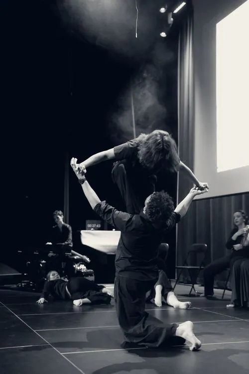 Performerka w głębokim skłonie na scenie